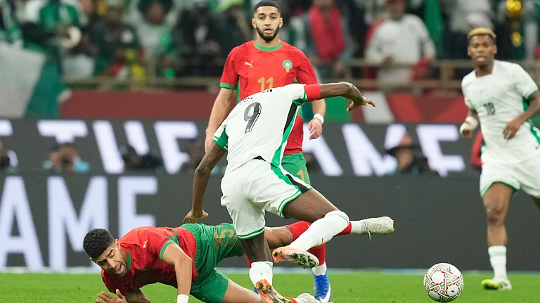 Morocco's Adam Masina and Nigeria's Victor Osimhen fight for the ball during the Africa Cup of Nations semi-final match on Wednesday, January 14, 2026. - | Photo: AP/Mosa'ab Elshamy