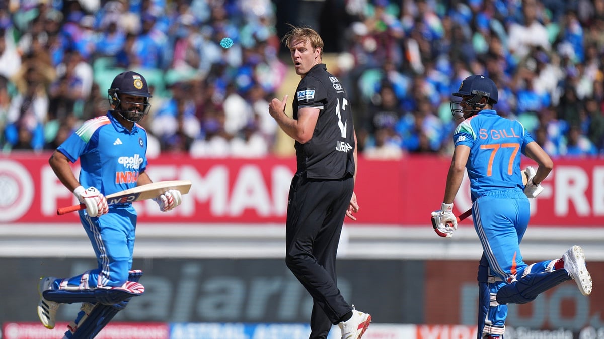 New Zealand's Kyle Jamieson reacts after bowls a deliver as India's Rohit Sharma and India's captain Shubman Gill run between the wickets to score during the second One Day International cricket match between India and New Zealand in Rajkot, India, Wednesday, Jan. 14, 2026.  - (AP Photo/Ajit Solanki)