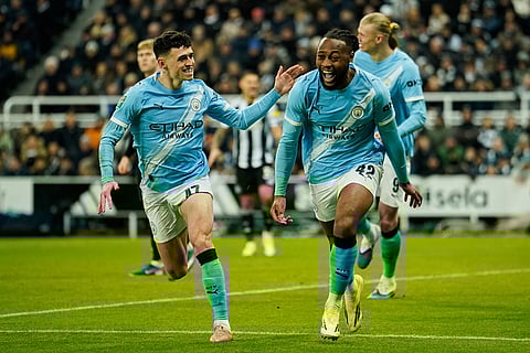 Manchester City's Antoine Semenyo, right, celebrates after scoring his side's opening goal during the English League Cup semifinal first leg soccer match between Newcastle and Manchester City in Newcastle, England.