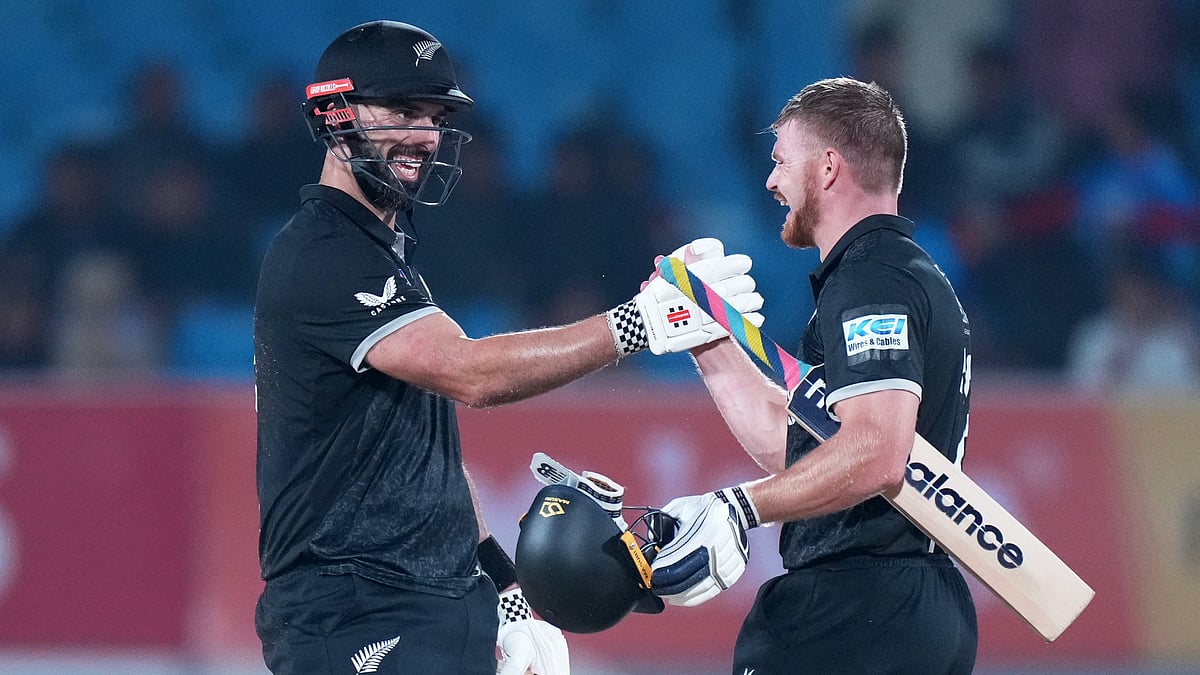 (AP Photo/Ajit Solanki) : New Zealand's Daryl Mitchell, left, and New Zealand's Glenn Phillips celebrate their win during the second One Day International cricket match between India and New Zealand in Rajkot, India, Wednesday, Jan. 14, 2026