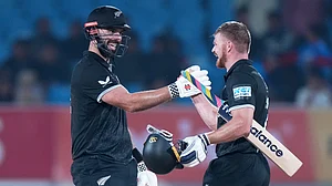 (AP Photo/Ajit Solanki) : New Zealand's Daryl Mitchell, left, and New Zealand's Glenn Phillips celebrate their win during the second One Day International cricket match between India and New Zealand in Rajkot, India, Wednesday, Jan. 14, 2026