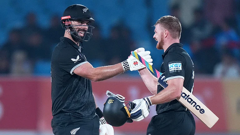 New Zealand's Daryl Mitchell, left, and New Zealand's Glenn Phillips celebrate their win during the second One Day International cricket match between India and New Zealand in Rajkot, India, Wednesday, Jan. 14, 2026 - (AP Photo/Ajit Solanki)