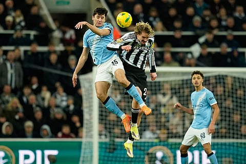 Manchester City's Abdukodir Khusanov, left, jumps for the ball with Newcastle's Nick Woltemade during the English League Cup semifinal first leg soccer match between Newcastle and Manchester City in Newcastle, England.