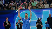 Australian Open 1-Point Slam 2026: Amateur Stuns Jannik Sinner To Win One Million AUD In Melbourne (James Ross/AAP Image via AP) : Australia's Jordan Smith holds his trophy aloft after defeating Joanna Garland of Taiwan to win the 1 Point Slam event ahead of the Australian Open in Melbourne, Australia, Wednesday, Jan. 14, 2026.