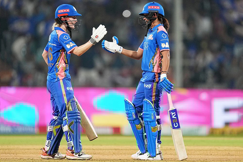 Mumbai Indians' captain Harmanpreet Kaur, right, and teammate Nicola Carey celebrate after winning the Women's Premier League (WPL) 2026 T20 cricket match against Gujarat Giants, at the DY Patil Stadium, in Navi Mumbai. - | Photo: PTI/Kunal Patil
