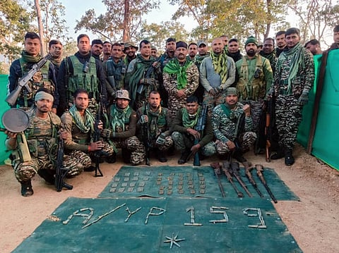 Chhattisgarh, Dec 31: Security personnel pose for a group picture with the large quantity of arms, explosives, and other Naxalite-related materials, in Sukma.