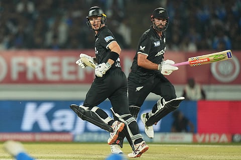 New Zealand's Daryl Mitchell, right, and New Zealand's Will Young run between the wickets to score during the second One Day International cricket match between India and New Zealand in Rajkot, India.