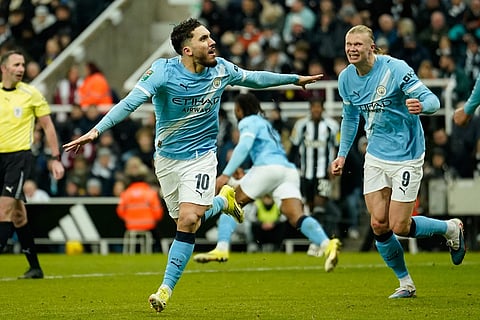 Manchester City's Rayan Cherki, left, celebrates after scoring his side's second goal during the English League Cup semifinal first leg soccer match between Newcastle and Manchester City in Newcastle, England.