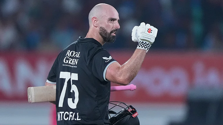 New Zealand's Daryl Mitchell celebrates after scoring a century during the second One Day International cricket match between India and New Zealand in Rajkot, India, Wednesday, Jan. 14, 2026 - (AP Photo/Ajit Solanki)
