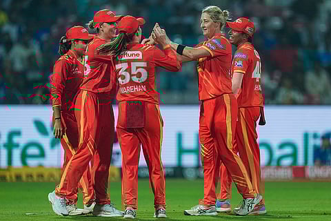 Gujarat Giants' Sophie Devine celebrates with teammates after taking the wicket of Mumbai Indians' Amanjot Kaur during the Women's Premier League (WPL) 2026 T20 cricket match between Gujarat Giants and Mumbai Indians, at the DY Patil Stadium, in Navi Mumbai.