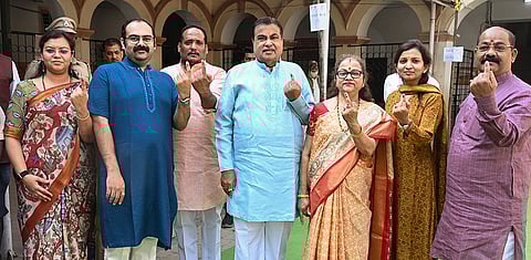 Union Minister Nitin Gadkari, center, with his family shows an inked finger after casting his vote at a polling booth during the Nagpur Municipal Corporation elections, in Nagpur, Maharashtra.