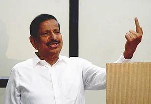 PTI : Maharashtra Forest Minister Ganesh Naik shows his ink marked finger after casting vote