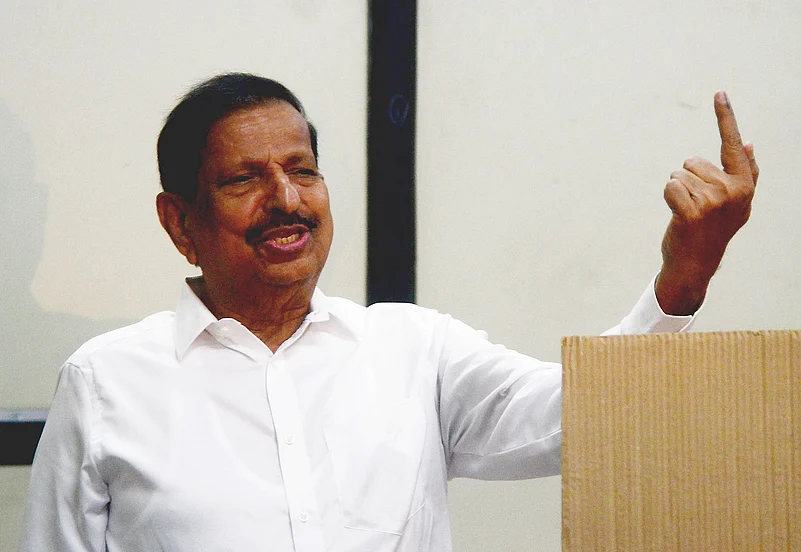 Maharashtra Forest Minister Ganesh Naik shows his ink marked finger after casting vote