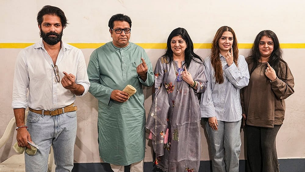 Maharashtra Navnirman Sena (MNS) chief Raj Thackeray with party leader and his son Amit Thackeray and other family members, shows his ink-marked finger after casting a vote in the Brihanmumbai Municipal Corporation (BMC) polls, in Mumbai. - | Photo: PTI/Kunal Patil