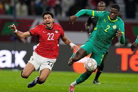 Egypt's Omar Marmoush, left, vies for the ball with Senegal's Mamadou Sarr during the Africa Cup of Nations semifinal soccer match between Senegal and Egypt, in Tangier, Morocco.