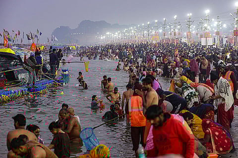 People take a holy dip at the Sangam on the occasion of 'Makar Sankranti' festival, during the ongoing 'Magh Mela', in Prayagraj.