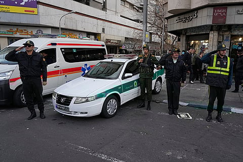 Policemen salute during a funeral ceremony for a group of security forces, who were killed during anti-government protests, in Tehran, Iran.