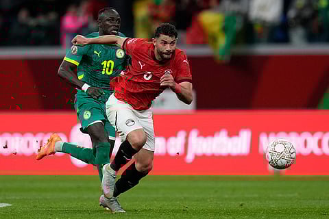 Egypt's Ramy Rabiaa is challenged by Senegal's Sadio Mane, left, during the Africa Cup of Nations semifinal soccer match between Senegal and Egypt, in Tangier, Morocco.
