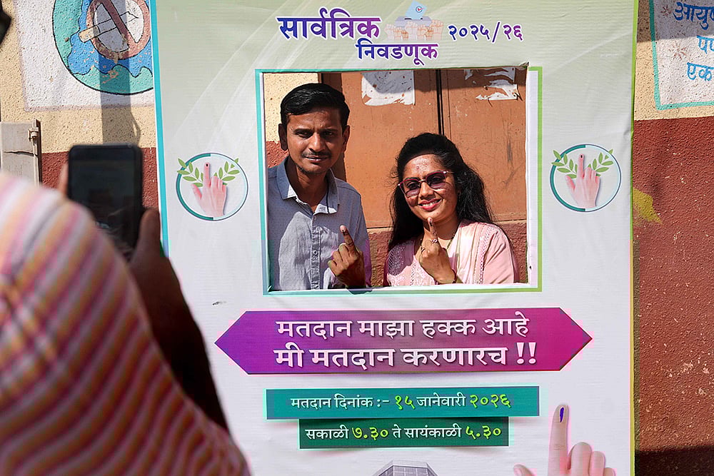 Voters pose infront of a selfie counter near the polling station - | Photo: Dinesh Parab/Outlook