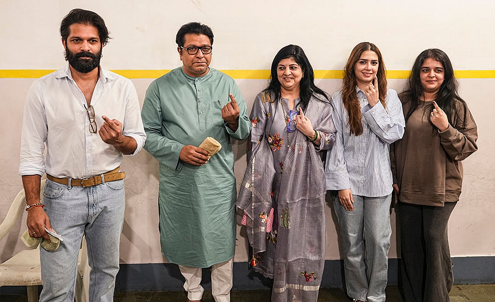 Maharashtra Navnirman Sena (MNS) chief Raj Thackeray with party leader and his son Amit Thackeray and other family members, shows his ink-marked finger after casting a vote in the Brihanmumbai Municipal Corporation (BMC) polls, in Mumbai. - | Photo: PTI/Kunal Patil