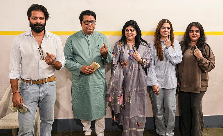 Maharashtra Navnirman Sena (MNS) chief Raj Thackeray with party leader and his son Amit Thackeray and other family members, shows his ink-marked finger after casting a vote in the Brihanmumbai Municipal Corporation (BMC) polls, in Mumbai. - | Photo: PTI/Kunal Patil