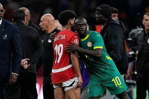 Senegal's Sadio Mane, right, hugs Egypt's Marwan Attia after the Africa Cup of Nations semifinal soccer match between Senegal and Egypt, in Tangier, Morocco.