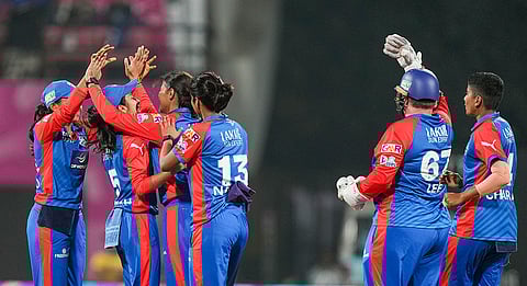 Delhi Capitals' Sneh Rana with captain Jemimah Rodrigues, and other teammates celebrates after the wicket of UP Warriorz's Phoebe Litchfield during a Women's Premier League (WPL) T20 cricket match between Delhi Capitals and UP Warriorz, at the DY Patil Stadium in Navi Mumbai.
