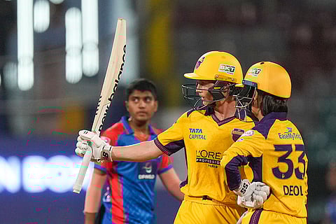 UP Warriorz's captain Meg Lanning, centre, with Harleen Deol celebrates her half century during a Women's Premier League (WPL) T20 cricket match between Delhi Capitals and UP Warriorz, at the DY Patil Stadium in Navi Mumbai.