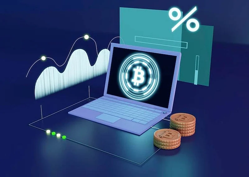 Laptop displaying Bitcoin symbol with charts, coins, and interest rate icon