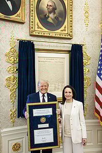 | Photo: @WhiteHouse/X via PTI  : Venezuelan opposition leader María Corina Machado presents her Nobel Peace Prize to US President Donald Trump during a meeting at the Oval Office, in Washington, DC. Machado, who has on previous occasions said that she would give her Nobel prize to Trump, met the American President in the White House Thursday, a closely-watched meeting that came days after the US carried out a military strike in Venezuela and captured its leader Nicolás Maduro. 