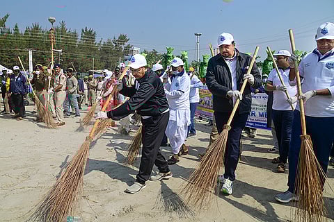 West Bengal Ministers Aroop Biswas, left, Sujit Bose, centre, and Pulak Roy, right, participate in beach-cleaning activities at Sagar Island during the 'Gangasagar Mela', in South 24 Parganas district of West Bengal.