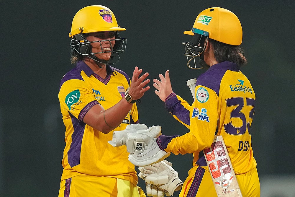 UP Warriorz' Chloe Tryon, left, and Harleen Deol celebrate after winning the Women's Premier League (WPL) 2026 T20 cricket match against Mumbai Indians, at the DY Patil Stadium, in Navi Mumbai. - | Photo: PTI/Kunal Patil