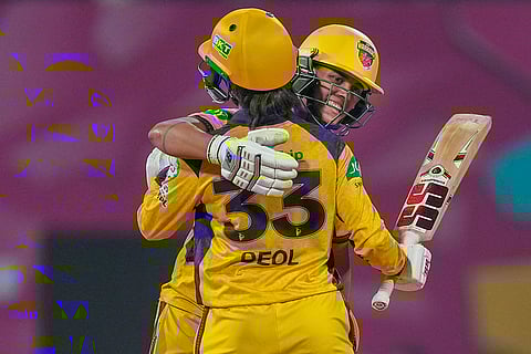 UP Warriorz' Harleen Deol celebrates with teammate Chloe Tryon after her half century during the Women's Premier League (WPL) 2026 T20 cricket match between Mumbai Indians and UP Warriorz, at the DY Patil Stadium, in Navi Mumbai.