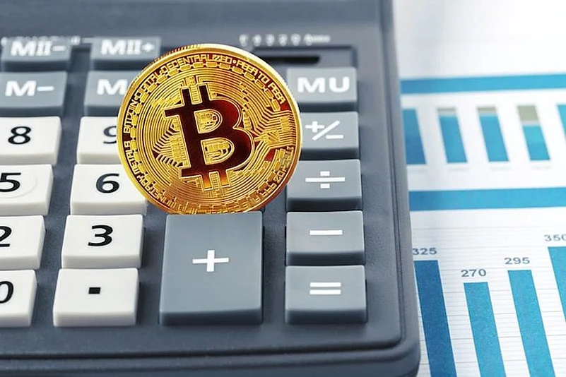 Bitcoin coin on calculator and chart