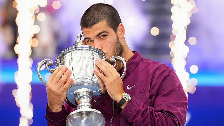 Carlos Alcaraz kisses the championship trophy after defeating Jannik Sinner, of Italy, in the men's singles final of the U.S. Open tennis championships. - File/AP