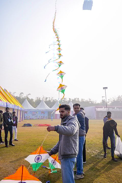 People fly a kite train during the third ‘International Kite Festival’, at Baansera Park, in New Delhi.