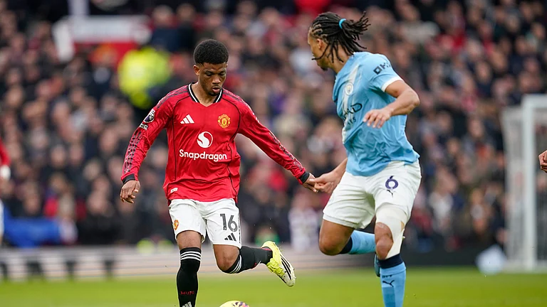 Manchester United's Amad Diallo, left, and Manchester City's Nathan Ake in action during the English Premier League soccer match between Manchester United and Manchester City in Manchester, England, Saturday, Jan. 17, 2026. - (AP Photo/Dave Thompson)
