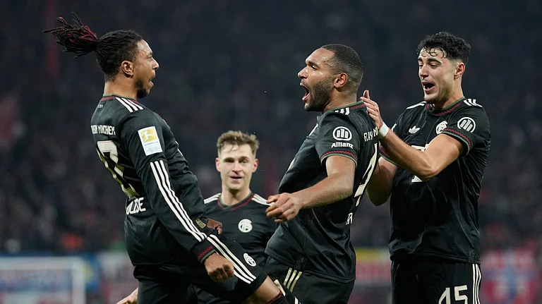 Bayern's Jonathan Tah celebrates with team mate Michael Olise after scoring his side's third goal during the Bundesliga soccer match between RB Leipzig and FC Bayern Munich in Leipzig, Germany, Saturday, Jan. 17, 2026. - (AP Photo/Matthias Schrader)