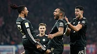 (AP Photo/Matthias Schrader) : Bayern's Jonathan Tah celebrates with team mate Michael Olise after scoring his side's third goal during the Bundesliga soccer match between RB Leipzig and FC Bayern Munich in Leipzig, Germany, Saturday, Jan. 17, 2026.