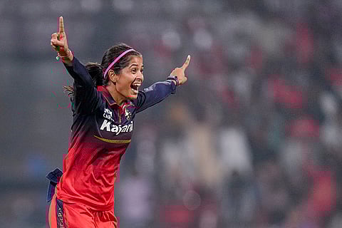 Royal Challengers Bengaluru's Shreyanka Patil celebrates after taking the wicket of Gujarat Giants' Tanuja Kanwar during the Women's Premier League (WPL) T20 cricket match between Royal Challengers Bengaluru and Gujarat Giants, at the DY Patil Stadium, in Navi Mumbai.