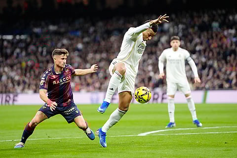 Real Madrid's Kylian Mbappe takes control of the ball during the Spanish La Liga soccer match between Real Madrid and Levante in Madrid, Spain.