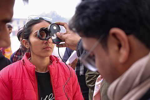 An aspirant undergoes security checks before being allowed to appear for the Uttar Pradesh Public Service Commission LT Grade Teacher exam, in Mathura.