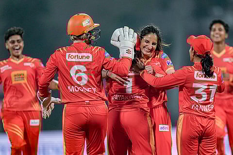 Gujarat Giants' Rajeshwari Gayakwad celebrates with teammates after taking a wicket during the Women's Premier League (WPL) T20 cricket match between Royal Challengers Bengaluru and Gujarat Giants, at the DY Patil Stadium, in Navi Mumbai.