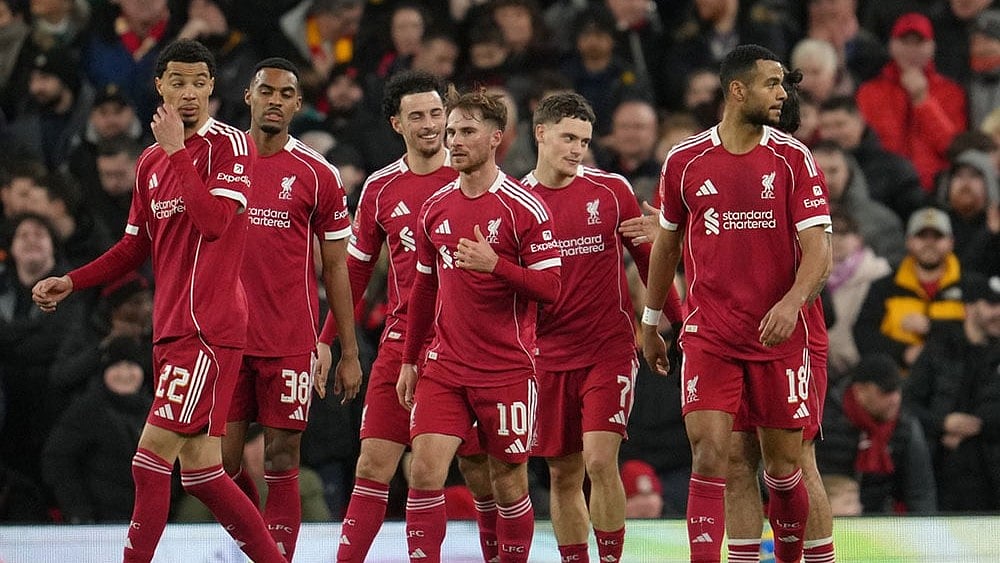 Premier League 2025-26 Live Scores, Saturday Goal Rush: Liverpool players walk to the ceneter after scoring during the FA Cup third round soccer match between Liverpool and Barnsley in Liverpool, England. - | Photo: AP/Jon Super