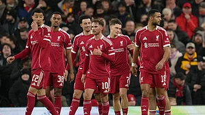 | Photo: AP/Jon Super : Premier League: Liverpool players walk to the ceneter after scoring during the FA Cup third round soccer match between Liverpool and Barnsley in Liverpool, England.