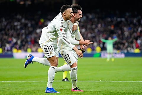 Real Madrid's Raul Asencio, right, celebrates with teammate Kylian Mbappe after scoring his side's second goal during the Spanish La Liga soccer match between Real Madrid and Levante in Madrid, Spain.