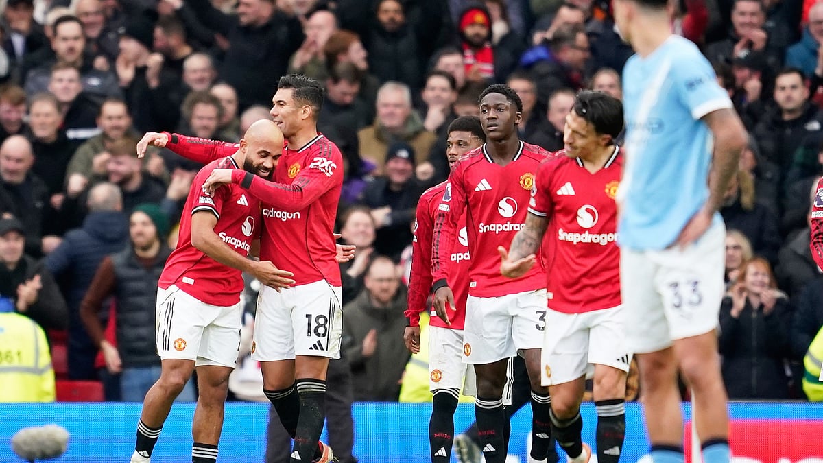 Manchester United's Bryan Mbeumo, left, celebrates after scoring his side's opening goal during the English Premier League soccer match between Manchester United and Manchester City in Manchester, England, Saturday, Jan. 17, 2026. - (AP Photo/Dave Thompson)