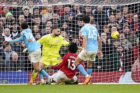 Manchester United's Patrick Dorgu, centre, scores his side's second goal during the English Premier League soccer match between Manchester United and Manchester City in Manchester, England.