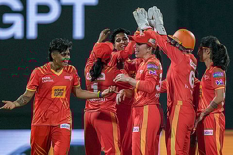 Gujarat Giants' Kashvee Gautam celebrates with teammates after taking the wicket of RCB's Dayalan Hemalatha during the Women's Premier League (WPL) T20 cricket match between Royal Challengers Bengaluru and Gujarat Giants, at the DY Patil Stadium, in Navi Mumbai.