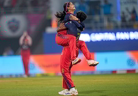 Royal Challengers Bengaluru's Shreyanka Patil, left, celebrates with teammate Arundhati Reddy after taking the wicket of Gujarat Giants' Tanuja Kanwar during the Women's Premier League (WPL) T20 cricket match between Royal Challengers Bengaluru and Gujarat Giants, at the DY Patil Stadium, in Navi Mumbai.